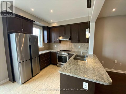 A kitchen with granite countertops and stainless steel appliances.
