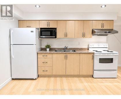 A kitchen with wooden cabinets and white appliances.