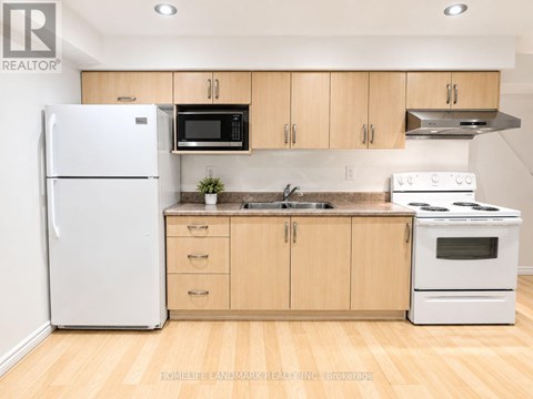 A kitchen with wooden cabinets and white appliances.