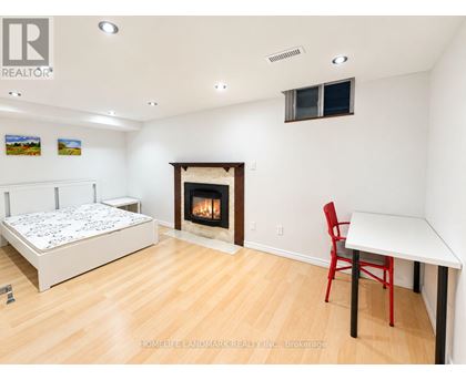 A bedroom with a fireplace and a bed.