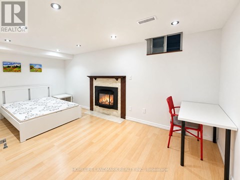 A bedroom with a fireplace and a bed.