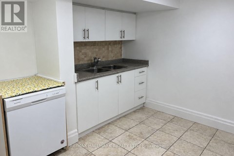 A small kitchen with a dishwasher and cabinets.