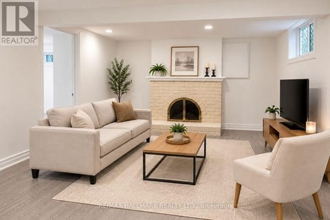 A living room with a couch, a coffee table, and a fireplace.