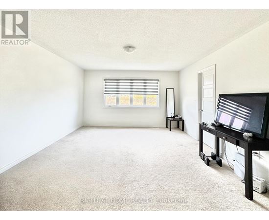 A living room with a television and a window with blinds.