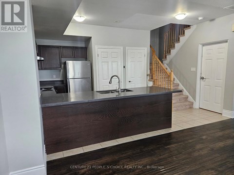 A kitchen with a wooden counter and a refrigerator.