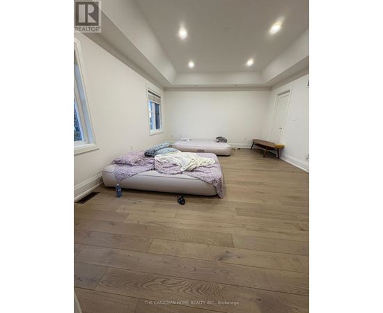 A bedroom with a bed and a bench in it.