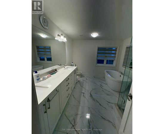 A bathroom with a marble floor and white countertops.