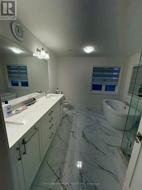 A bathroom with a marble floor and white countertops.