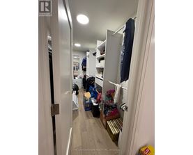 A hallway with a door on the left and a closet on the right.