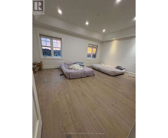 A bedroom with a bed and a sofa in it.
