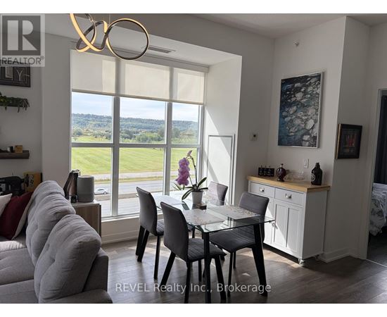 A dining room with a table set for four and a view of the outdoors.