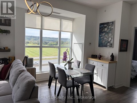 A dining room with a table set for four and a view of the outdoors.