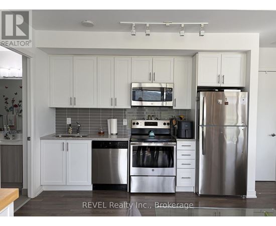 A kitchen with white cabinets and stainless steel appliances.