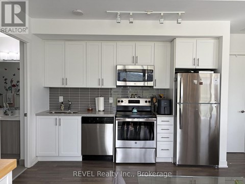 A kitchen with white cabinets and stainless steel appliances.
