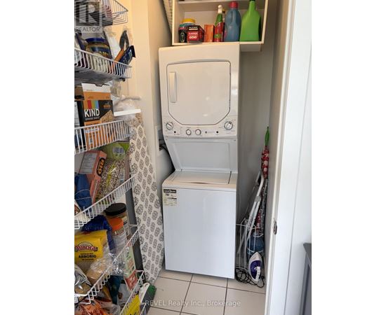 A white washing machine is in a small laundry room.