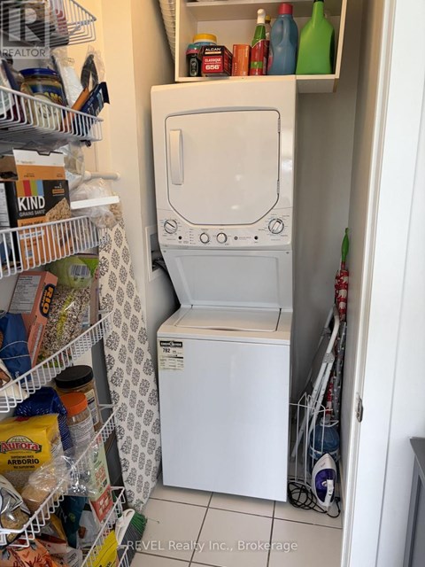 A white washing machine is in a small laundry room.