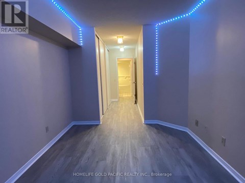 A hallway with a person standing at the end.