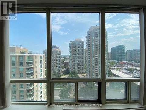 A view of a cityscape from a window in a building.