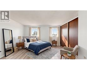 A bedroom with a bed, chair, and mirror.