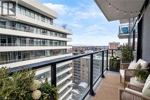 A balcony with a chair and a table with a potted plant on it.
