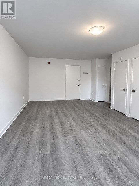 A room with grey flooring and white walls.