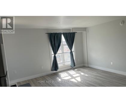 A room with a window and curtains, and a logo that says REALTOR.
