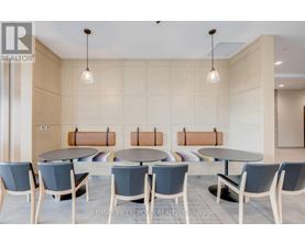 A conference room with a table and chairs.