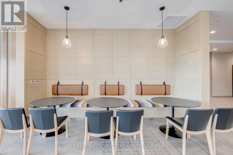 A conference room with a table and chairs.