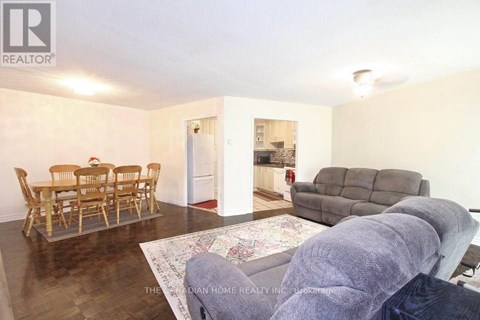 A living room with a dining table and chairs.