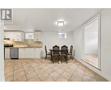 A dining room with a table set for four.