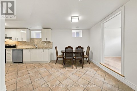 A dining room with a table set for four.