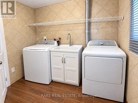 A small laundry room with a washer and dryer in it.