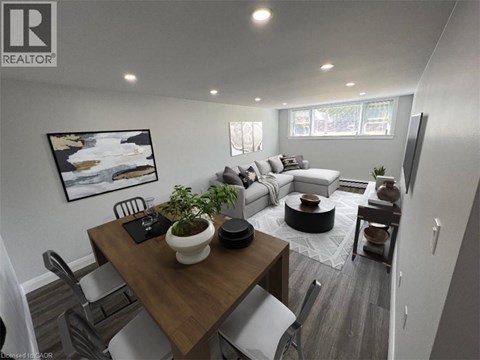 A modern living room with a dining table and chairs.