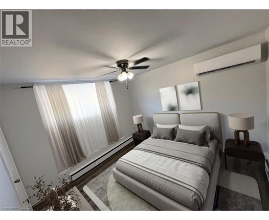A bedroom with a large bed and a ceiling fan.