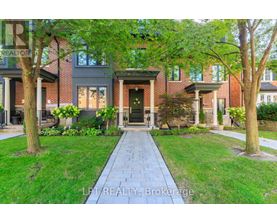 A brick house with a tree in front of it.