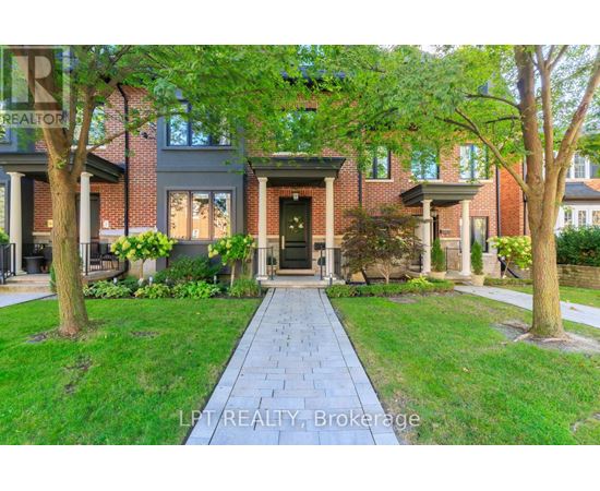 A brick house with a tree in front of it.