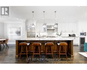 A modern kitchen with a large island and bar stools.