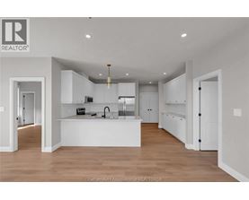 A modern kitchen with white cabinets and a central island.