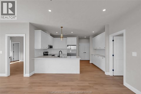A modern kitchen with white cabinets and a central island.