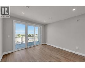 A room with a sliding glass door leading to a balcony.