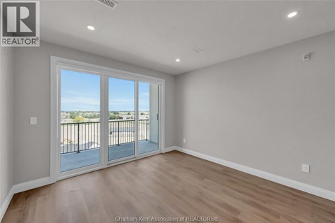 A room with a sliding glass door leading to a balcony.