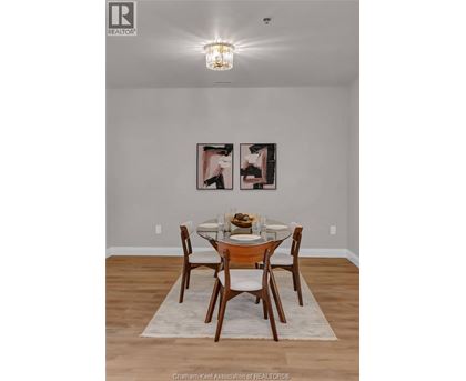 A dining room with a table set for two.