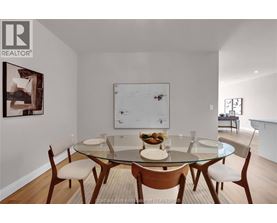 A dining room with a glass table and chairs.