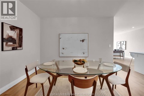 A dining room with a glass table and chairs.