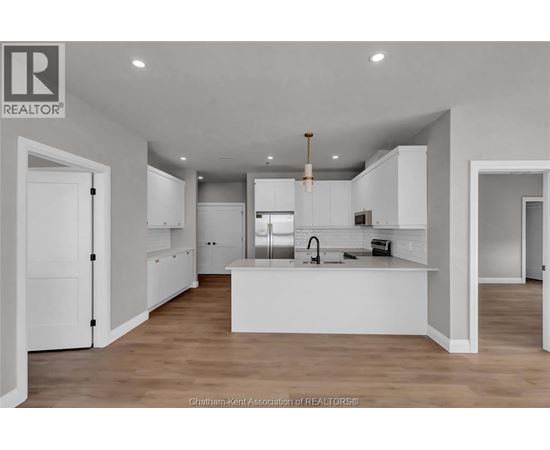 A modern kitchen with white cabinets and a central island.