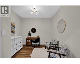 A white room with a desk and chairs.