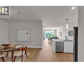 A modern kitchen with a dining table and chairs.