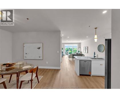 A modern kitchen with a dining table and chairs.