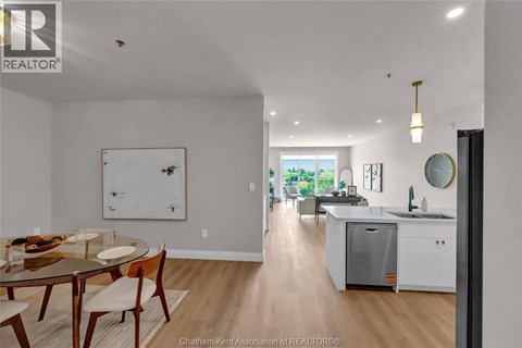 A modern kitchen with a dining table and chairs.