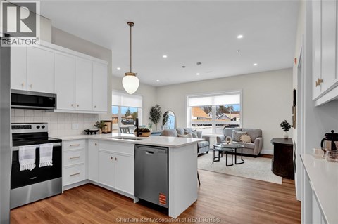 A modern kitchen with white cabinets and a large island.